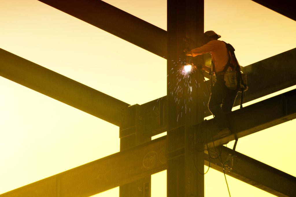 construction worker handling structural steel